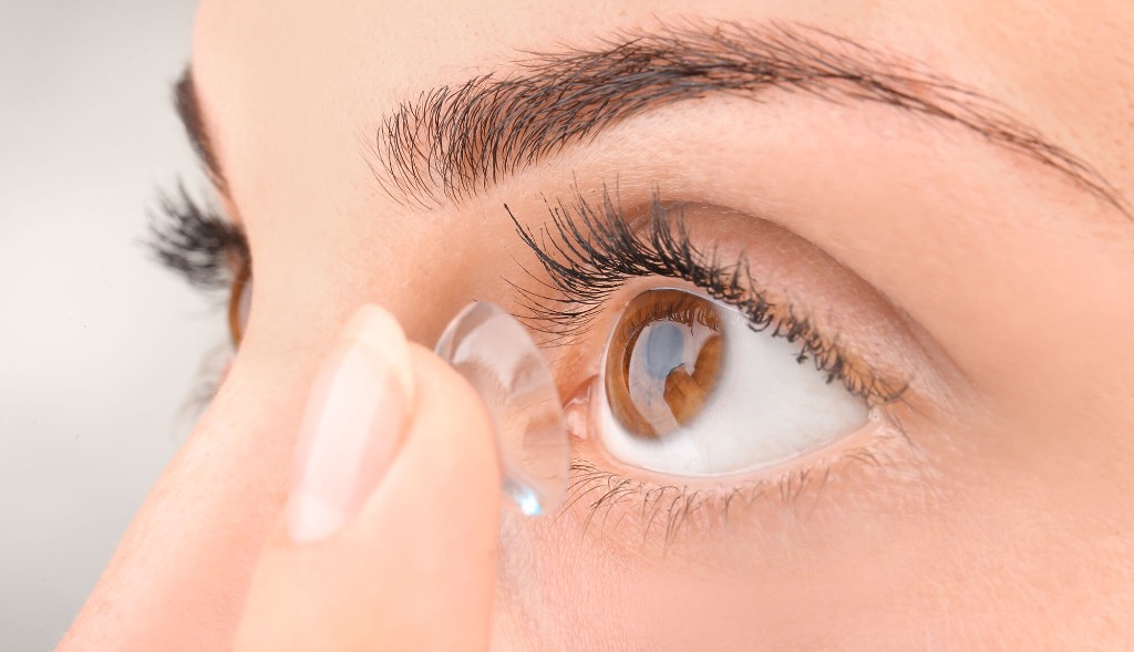 Close-up of a contact lens being placed on the eye